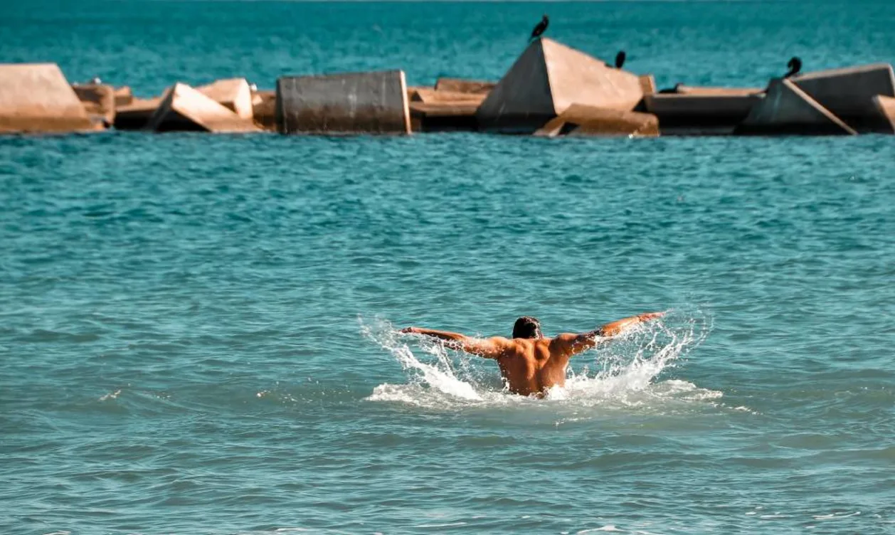 Man swimming in ocean off coast of Barcelona